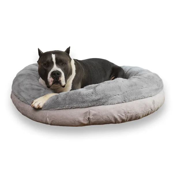 A grey and white bully breed lying in a grey Faux Fur round Bully Bed