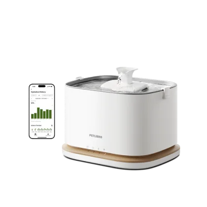 The Petlibro Dockstream 2 fountain as Petlibro photographs it: white tank on a wood-tone base with water running over the spout, the app screen beside it